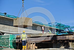 Construction workers stacking the maintain load test block at the construction site